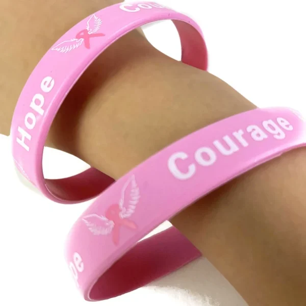 Breast Cancer Awareness Bracelets on a person's wrist.