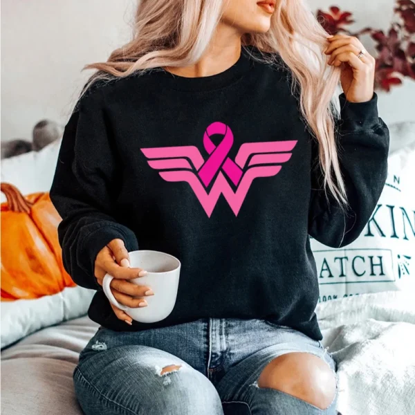 A woman sitting on a bed holding a Superhero Sweatshirt.