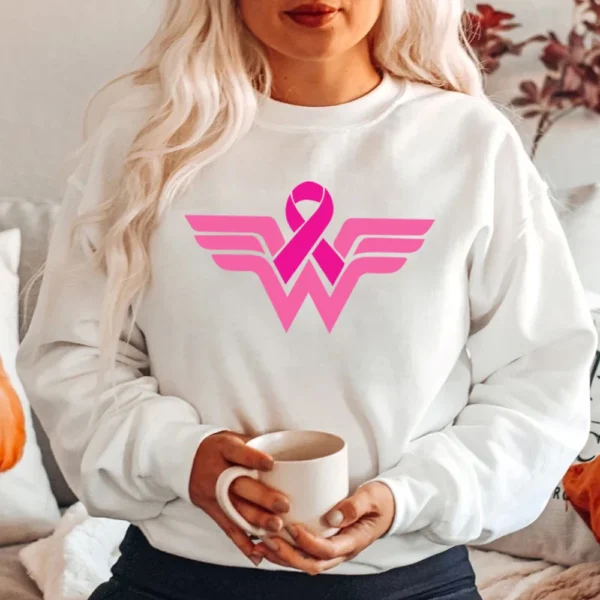 A woman wearing a Superhero Sweatshirt with a pink breast cancer ribbon.