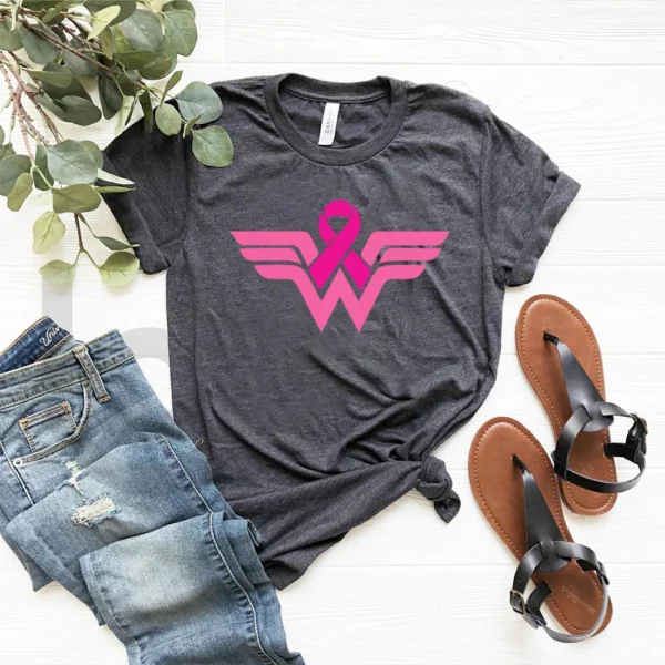 A superhero t-shirt and sandals on a white surface.