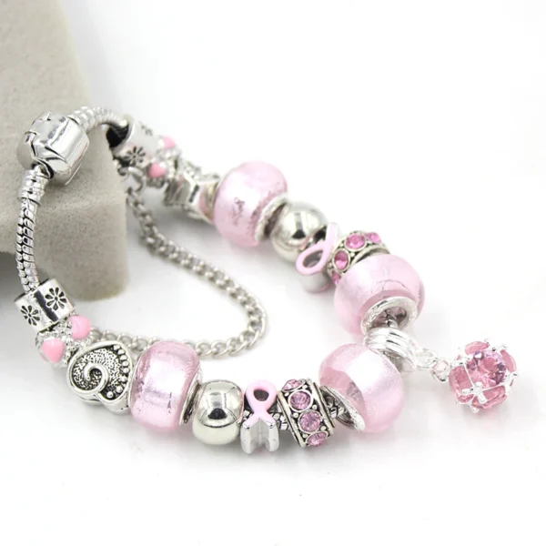 A Ball Bead Bracelet with pink beads and silver charms.