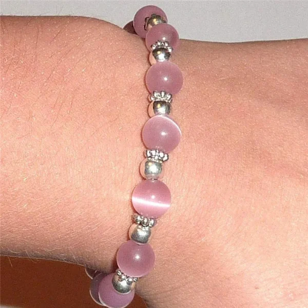 A person wearing a Pink Ribbon Beaded Bracelet with silver beads.