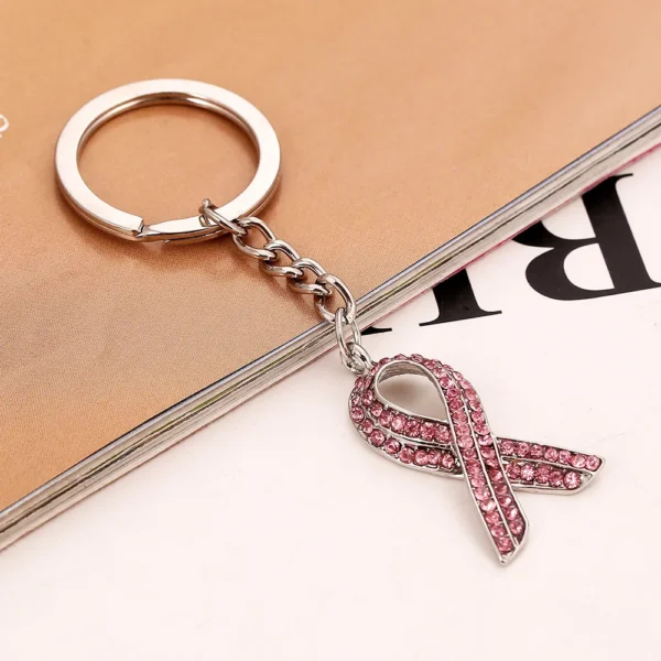 A Crystal Rhinestone Key Chain with a pink ribbon on it.