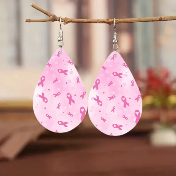 Water drop earrings hanging from a branch.