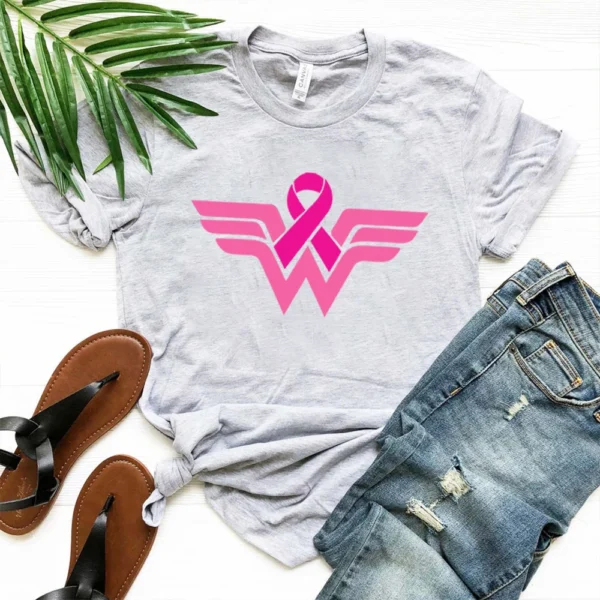 A Superhero T-shirt and sandals on a white surface.