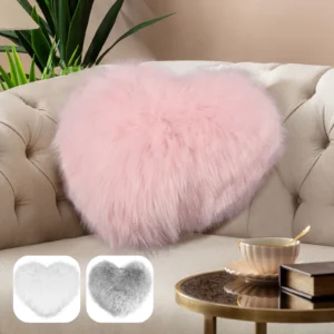 A pink and white Soft Plush Heart Shaped Pillow in a living room.